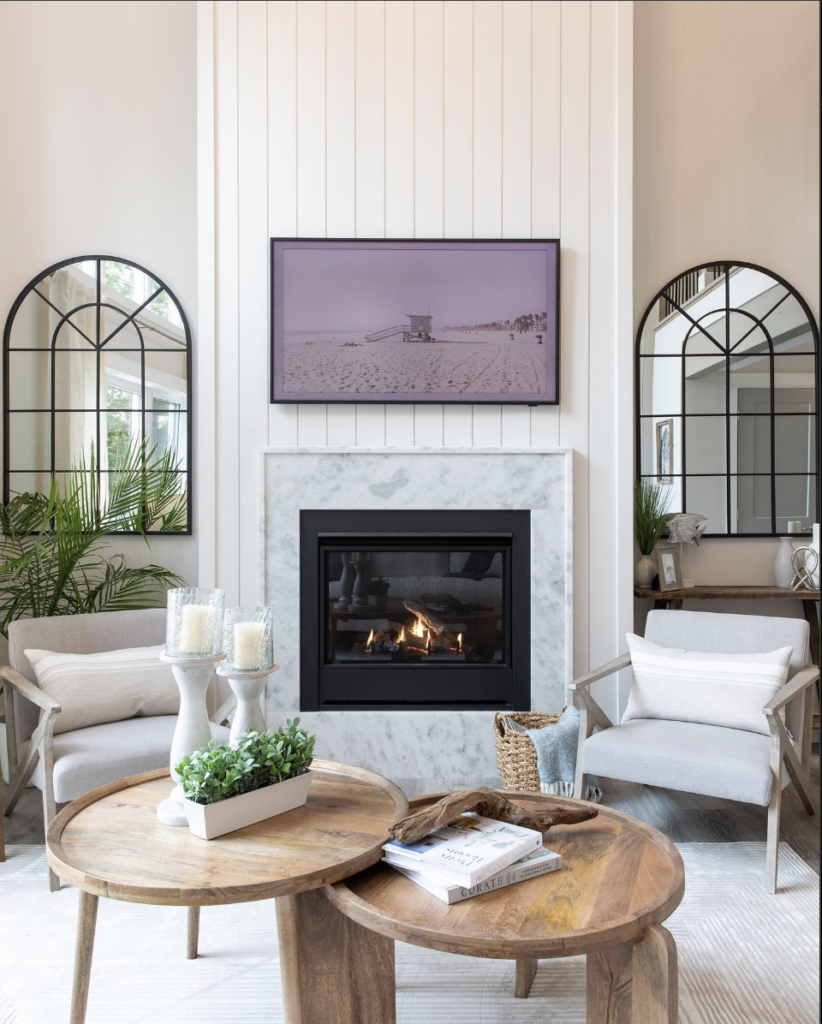 Electric fireplace with TV above on white shiplap accent wall