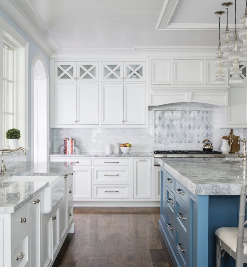 Silver Hardware on White Cabinetry with a Blue Island