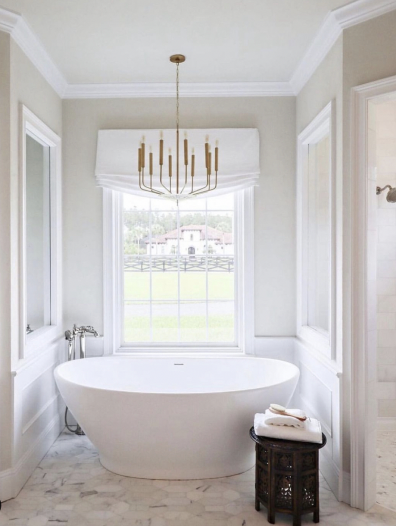 Sleek Chandelier in Brass over a White Bathtub