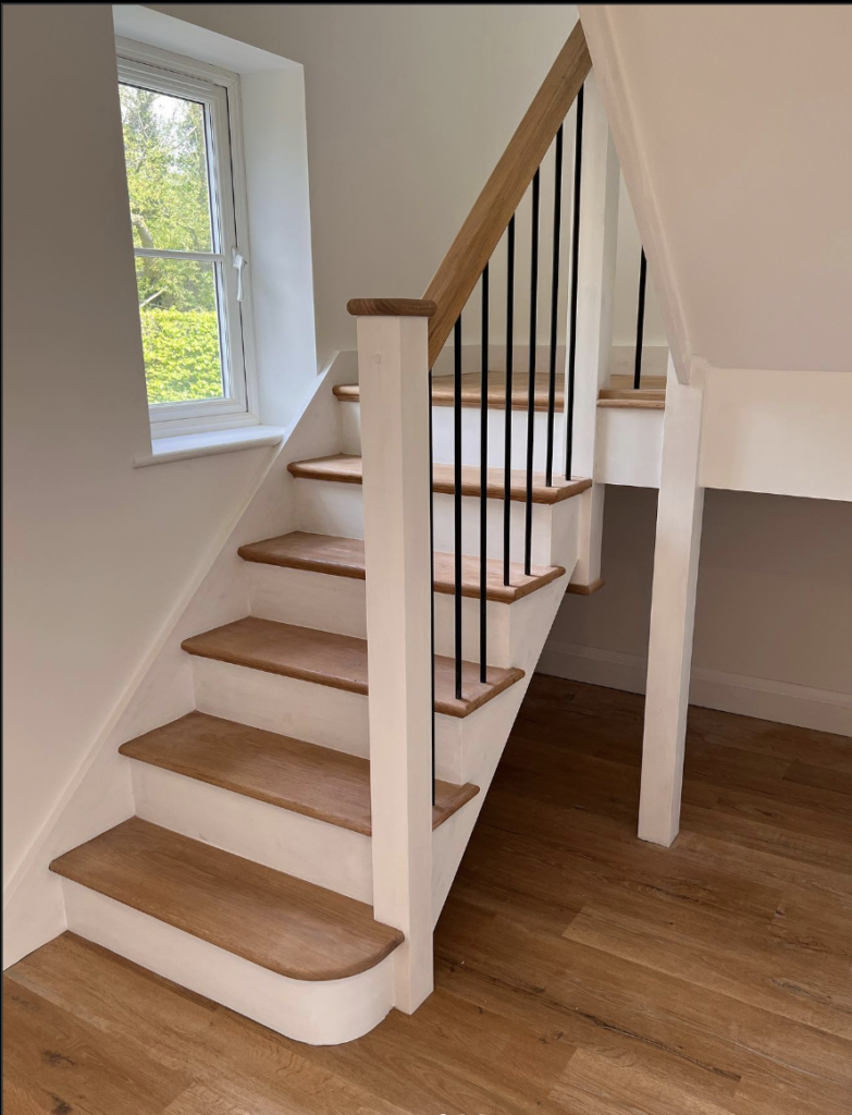 Staircase with white risers and wooden steps