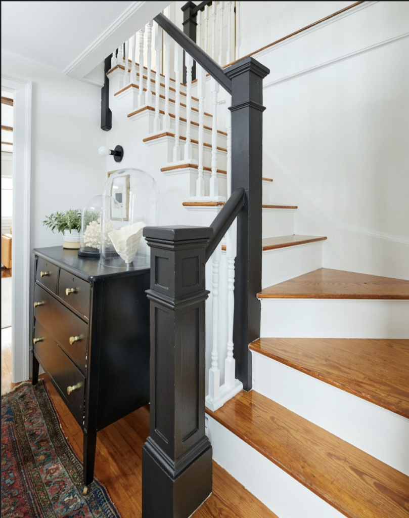 Staircase with white wood and black railing