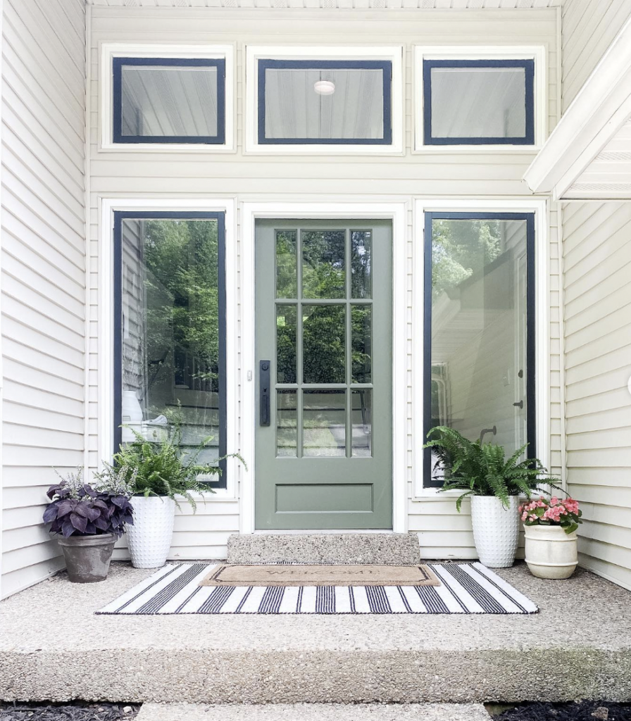 Striped White and Black Mat in Front of a Green Door