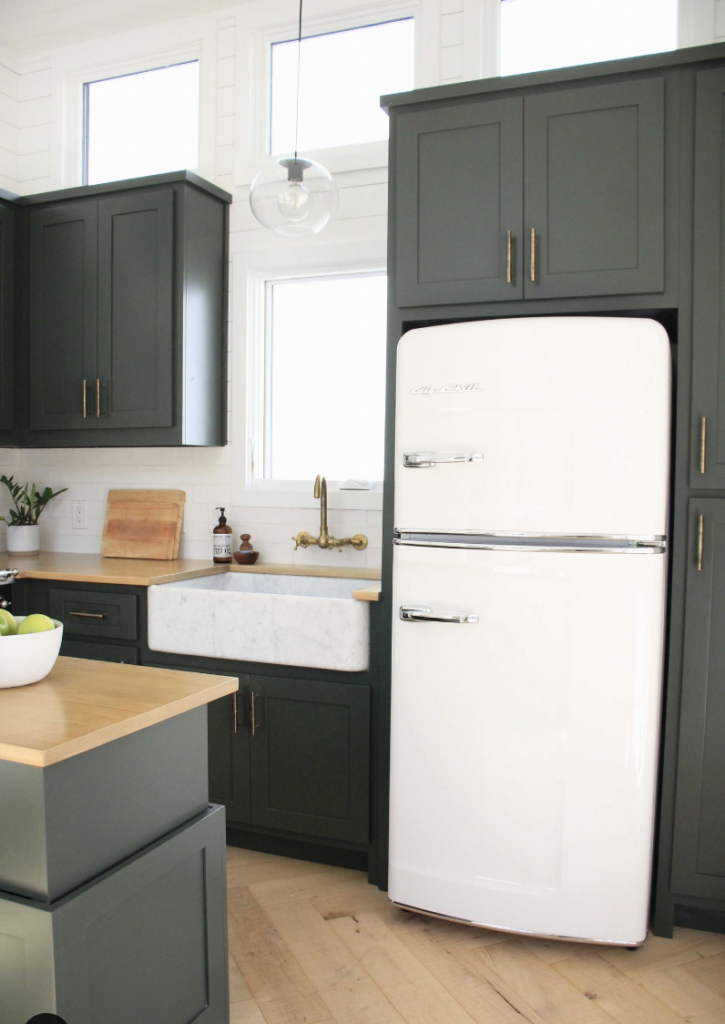 The White Fridge and Cabinets Above It in Dark Green