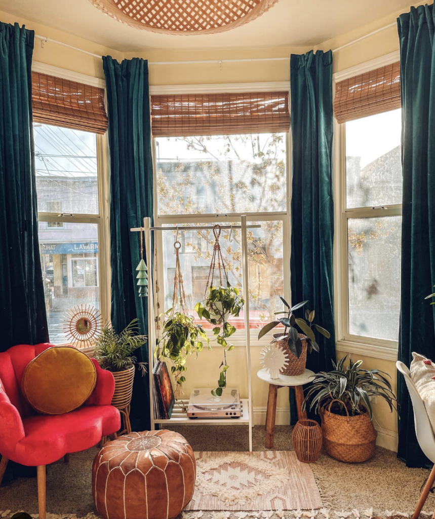 Turquoise Velvet Curtains and Brown Blinds for a Bay Window