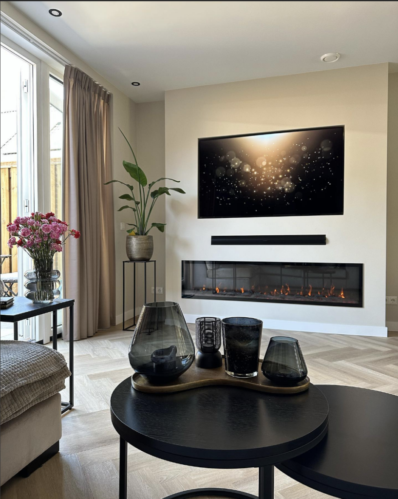 Minimalist wall mounted electric fireplace with TV above