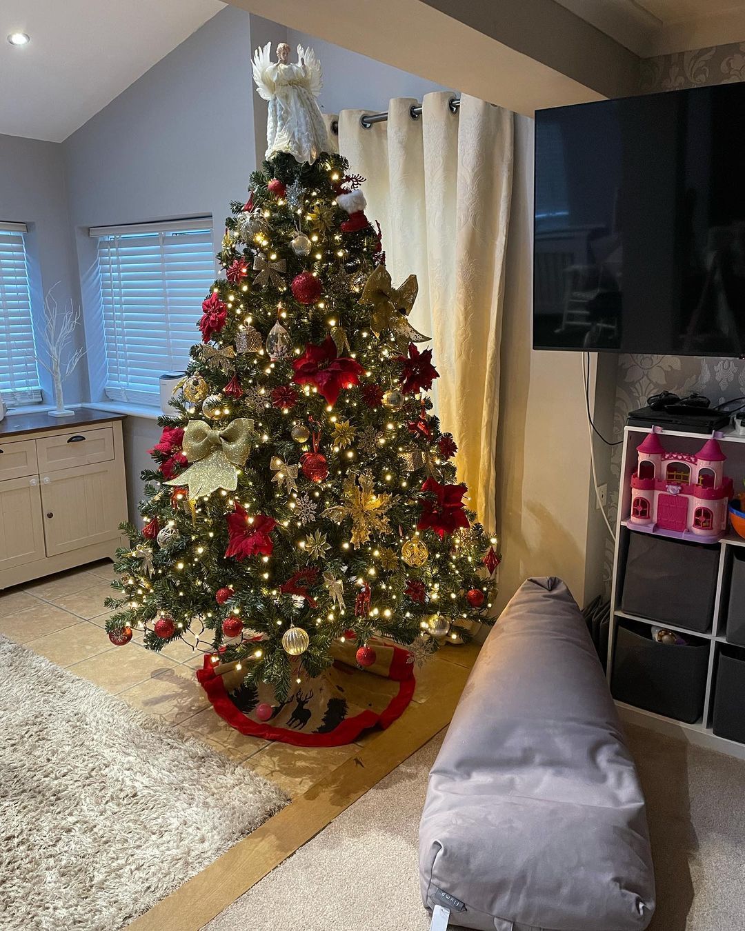 Twinkling Lights and an Angel on a Red and Gold Tree