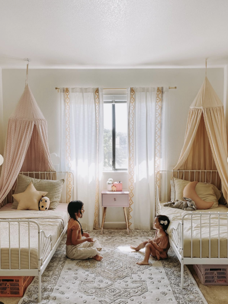Two Beds in a Children's Bedroom with a Large Window