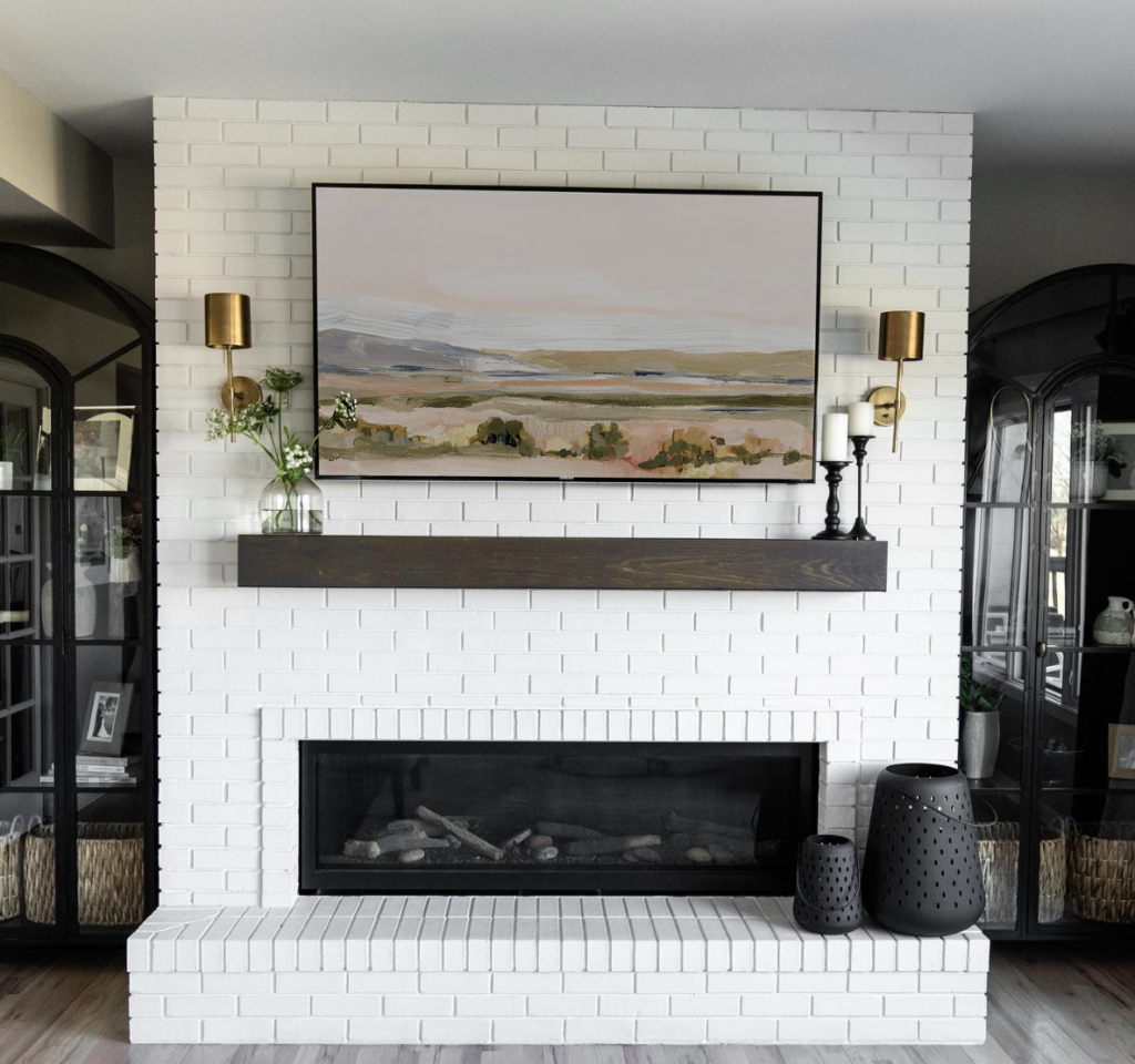 Two Brass Sconces Beside a Brick Fireplace