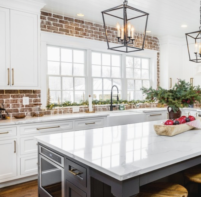 Two White Windows Above a Brick Backsplash
