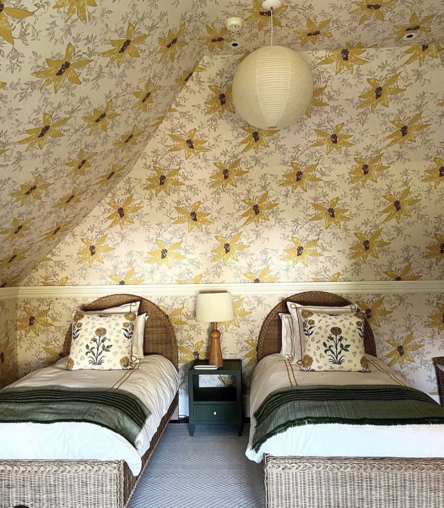 Warm Yellow Mural with Two Rattan Beds