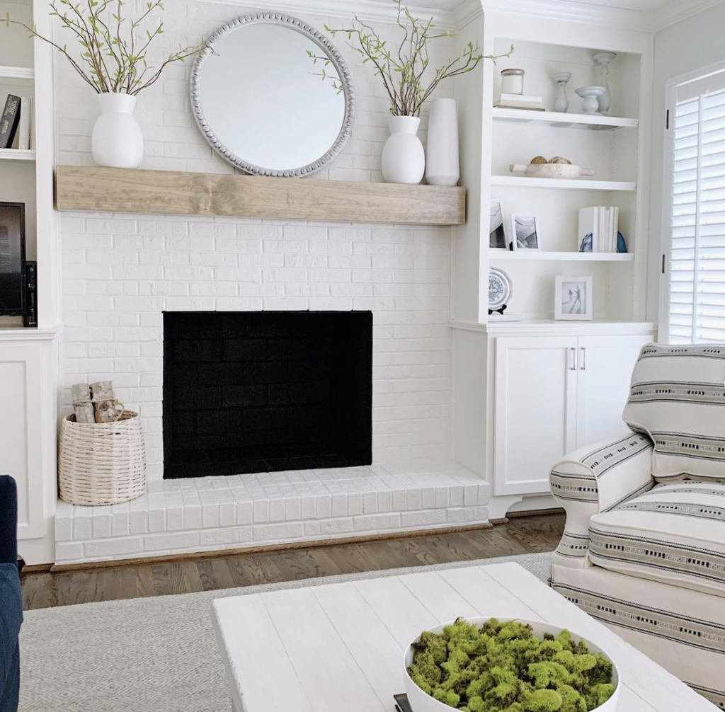 White Brick Fireplace Flanked by Two Built-Ins