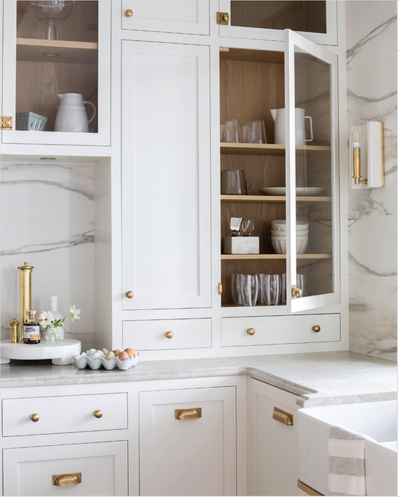 White Cabinetry with Gold Hardware Faucet Light and Wood Accent