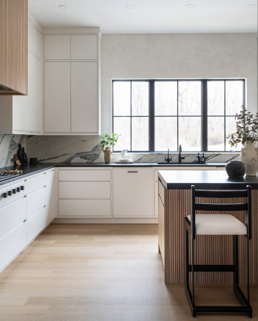 White Cabinets with a Black Counter and Sink Window
