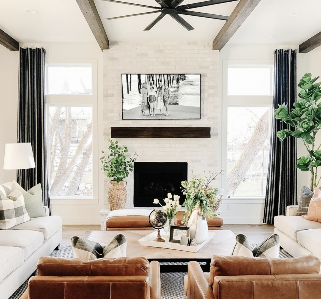 White Fireplace Framed by Large Windows