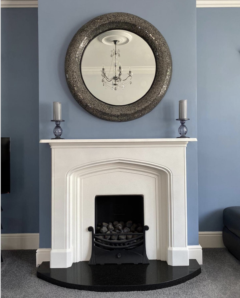 White Fireplace with Empty Black Granite Hearth