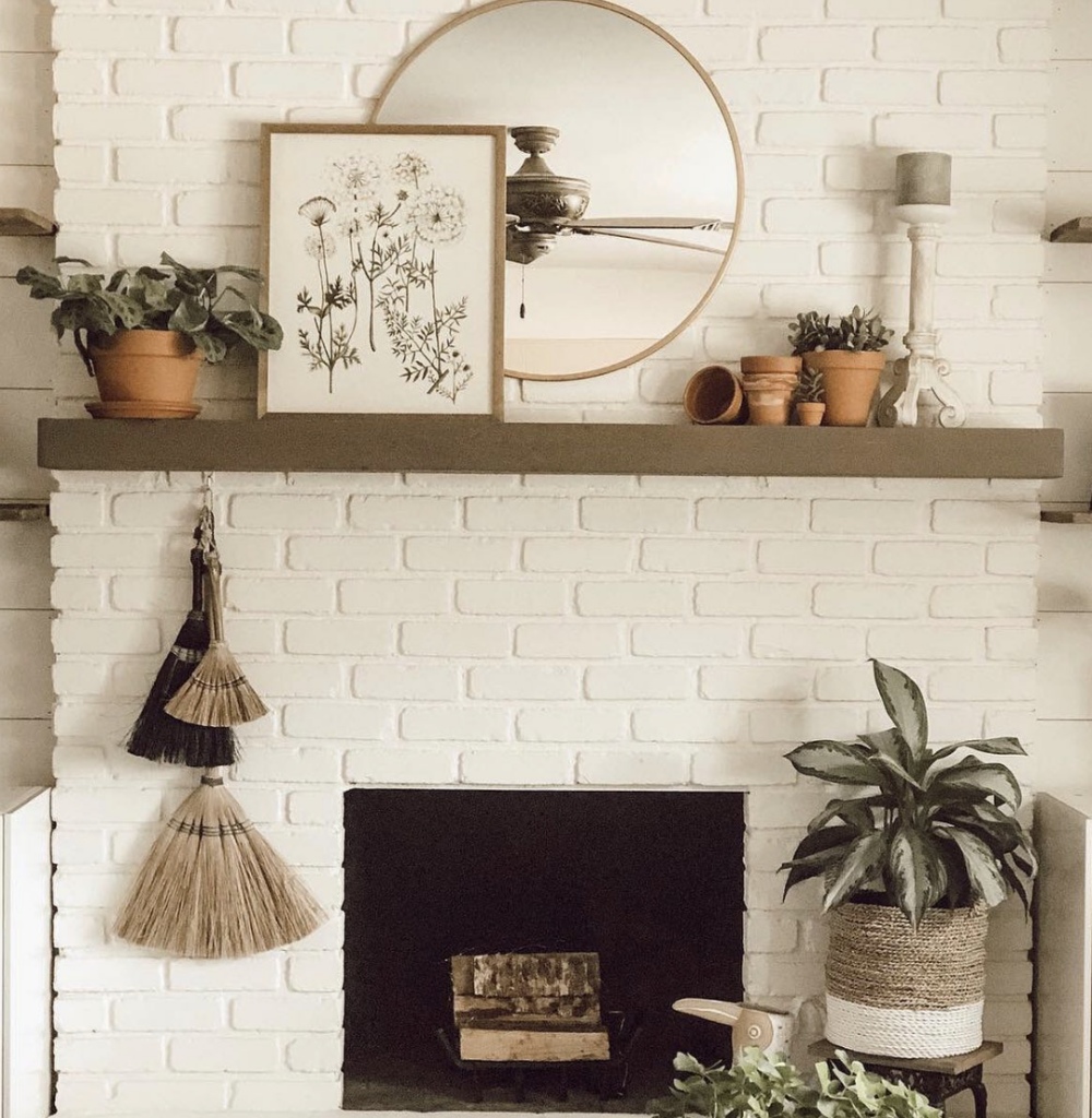 White Fireplace with Vibrant Greenery