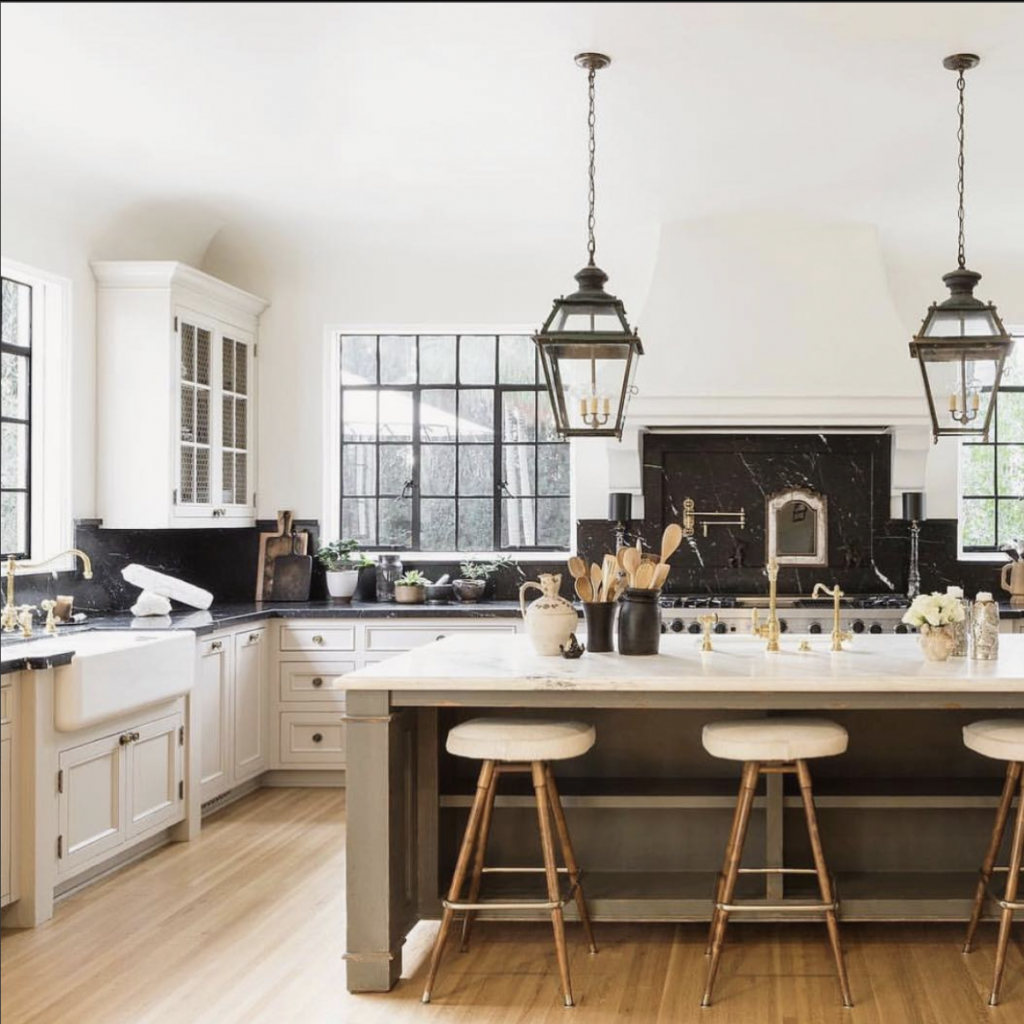 White Kitchen with Black Counters and Granite Backsplash