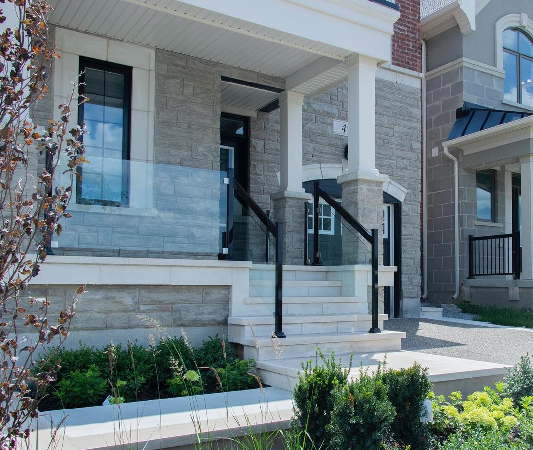 White marble steps and a sleek glass porch railing