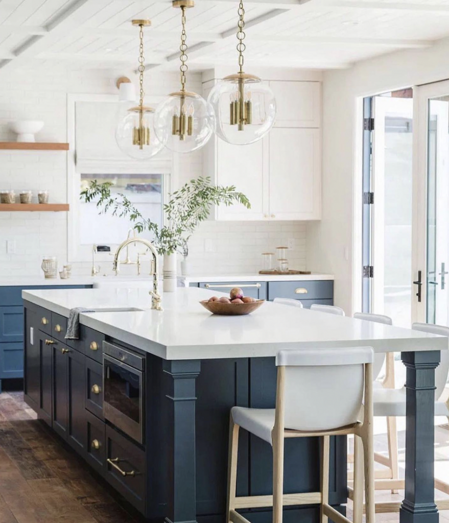 White Shaker Cabinets With a Blue Island