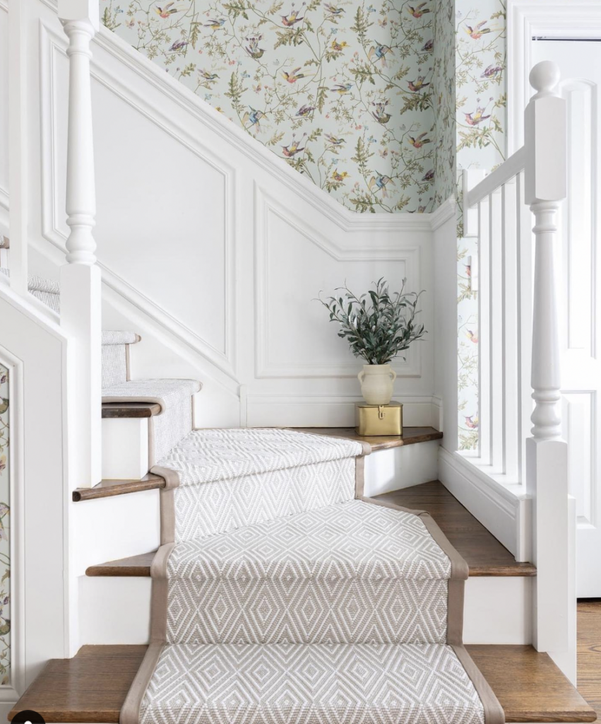 White Wainscoting with Nature-Inspired Staircase Wallpaper