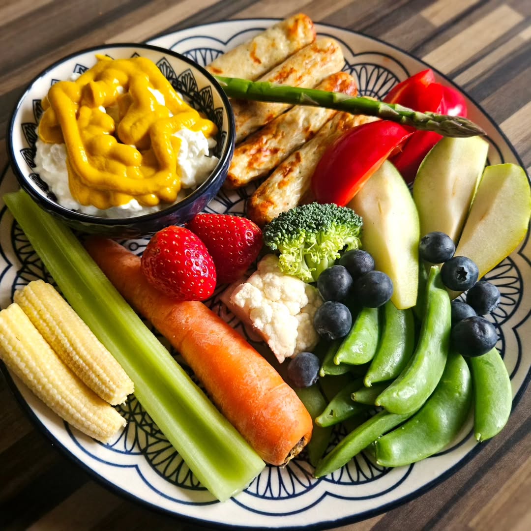 Elegant Tiffany Plate with grilled chicken strips, asparagus, strawberries, blueberries, and pear slices