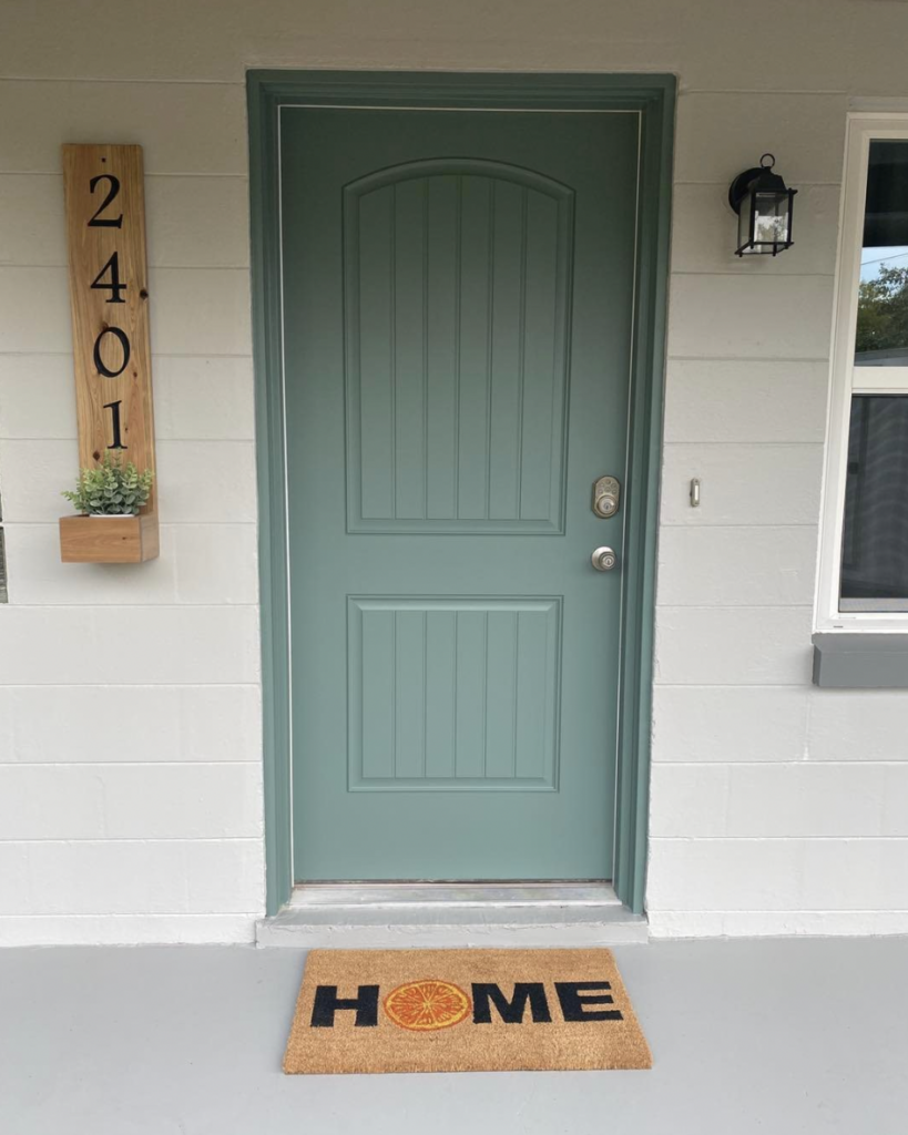 Wooden Accents on a Sage Green Entrance Door