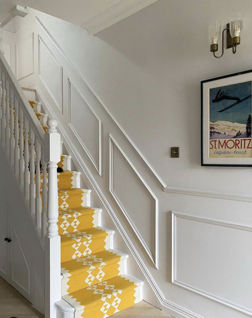 Yellow Staircase Runner and White Board-and-Batten Skirt Board